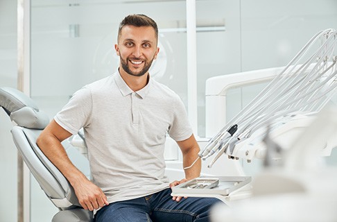 A male patient sitting on a dentist’s chair